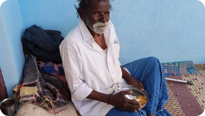 Elderly man receiving a meal from the foundation volunteer