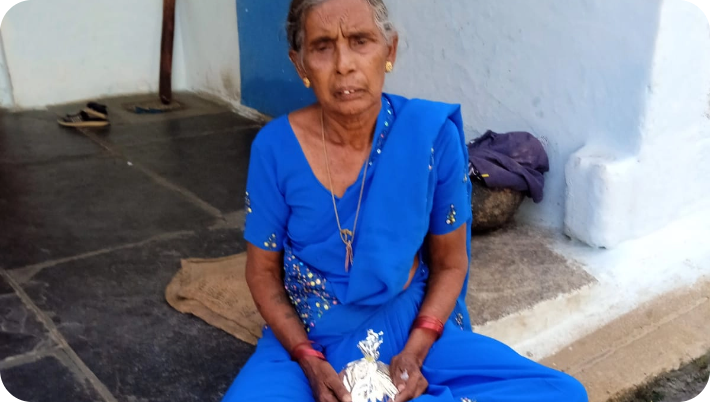 Volunteer serving food to elderly villagers during a community meal event