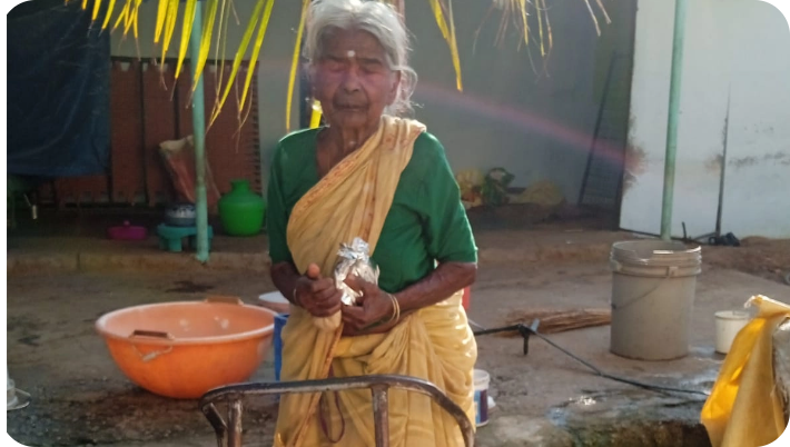 Group of elderly villagers enjoying a meal together at a foundation gathering
